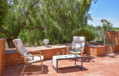 two chairs and a table on a patio at Villa Trappeto in Trappeto