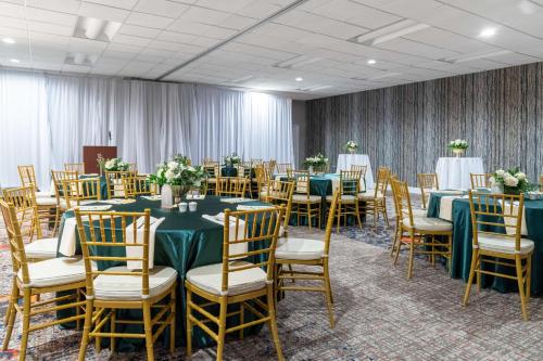 a banquet room with green tables and chairs at Hilton Garden Inn San Francisco/Oakland Bay Bridge in Emeryville