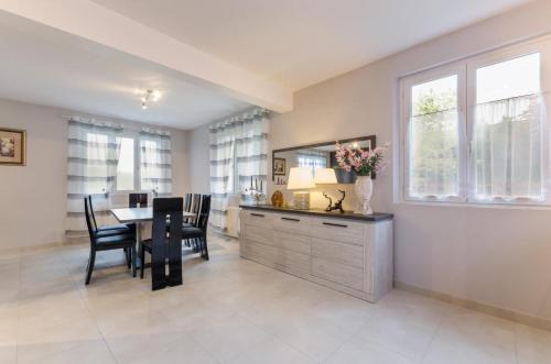 a kitchen and dining room with a table and chairs at La rose d'henri in Landreville