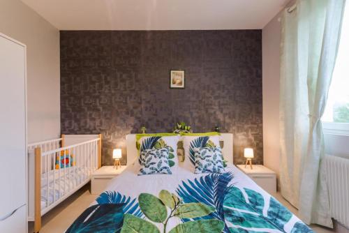 a bedroom with a large bed with blue pillows at La rose d'henri in Landreville