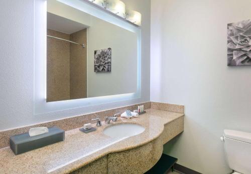 a bathroom with a sink and a mirror at La Quinta by Wyndham Fort Worth NE Mall in Hurst