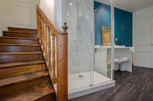 a bathroom with a walk in shower and a staircase at L'instant champenois & son annexe in Bréviandes