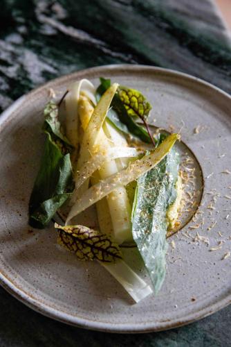 a plate of food with vegetables on a table at Château De La Bûcherie in Saint-Cyr-en-Arthies