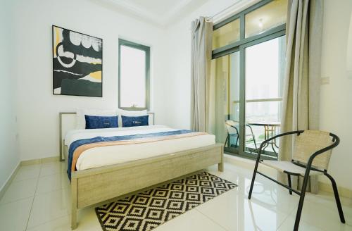 迪拜Citi home Business bay的一间卧室，里面有一张床、一把椅子和一扇窗户