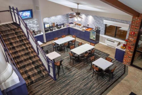 an overhead view of a restaurant with tables and a counter at AmericInn by Wyndham Peoria in Peoria