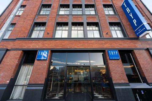 a large brick building with a large window at TRYP by Wyndham Wellington, Tory Street in Wellington