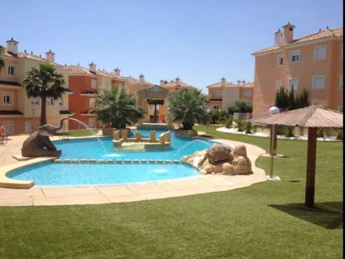 a large swimming pool in a yard with a playground at Apto. residencial en Murcia in Murcia