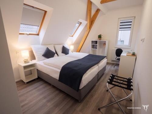 a bedroom with a bed and two windows at Penzion Korida in Ústí nad Labem