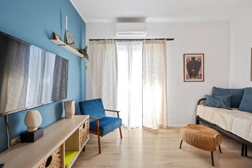 a living room with a bed and a tv at Regina Apartments in Brodarica