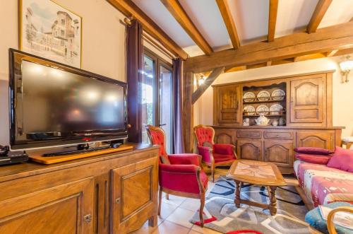 a living room with a large flat screen tv at La sablonniere in La Ville-aux-Bois