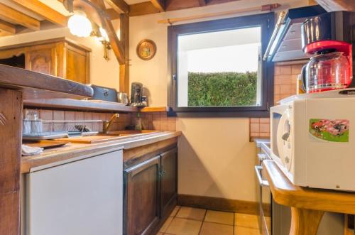 a kitchen with a sink and a window at La sablonniere in La Ville-aux-Bois