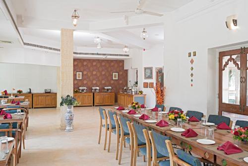 a large dining room with a long table and chairs at The Chitvan Resort in Ajmer