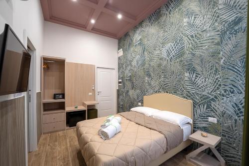 a bedroom with a bed and a wall mural at P.C. Boutique Medina H. Napoli Centro, by Clapa Group in Naples