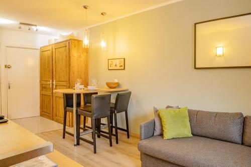 a living room with a couch and a table at Apartment Lognan 1 in Chamonix