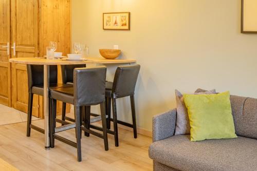 a living room with a table and a couch at Apartment Lognan 1 - A Chamonix Mont Blanc Haven in Chamonix-Mont-Blanc