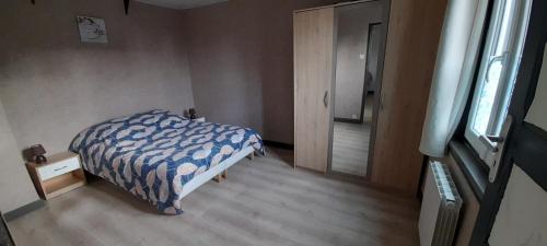 a bedroom with a bed and a window and a door at Gite Seb et Delphine in Montauban-de-Picardie