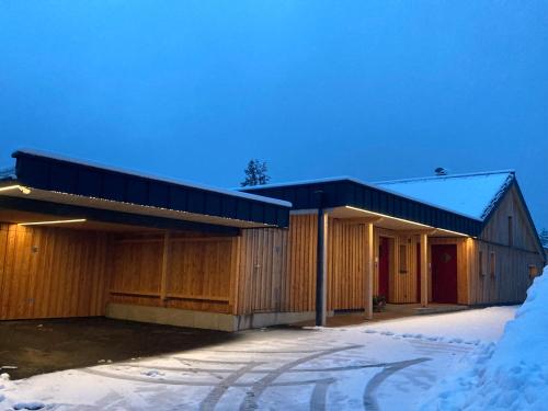 a wooden building with snow on the ground at Stadtfüchse plus Sauna in Bad Ischl