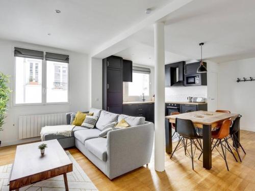 un salon avec un canapé et une table dans l'établissement Amazing Apartment: 2BR/4P -Bastille/Saint Ambroise, à Paris