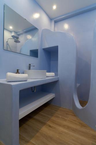 a bathroom with a sink and a mirror at La maison - Two Private Apartments, One with Private Pool in Angairiá