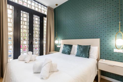 1 dormitorio con 2 camas y pared verde en Anelsa Torres de Serranos 3, en Valencia