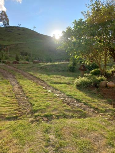 a dirt road in the middle of a field at Chalé Araucária- Vale das Pedras MG in Sapucaí-Mirim