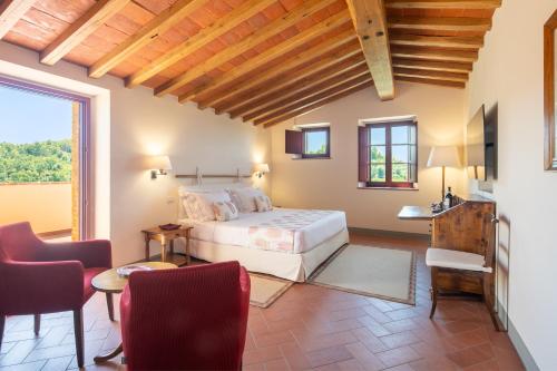 a bedroom with a bed and a table and chairs at The Club House in Castelnuovo Berardenga