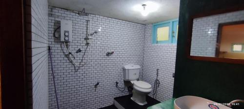 a bathroom with a toilet and a shower and a sink at Home sweet in Ahanagama villa in Ahangama
