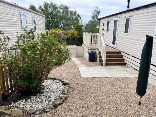 a backyard with a house and a yard with a stairway at Beauport Holiday Park in Hastings