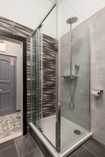 a shower with a glass door in a bathroom at Molo Longo - Downtown Apartments in Rijeka