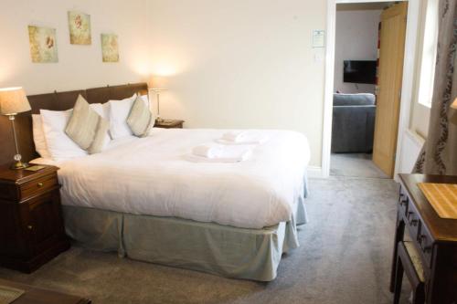 a bedroom with a large bed and a couch at Sharp Edge in Penrith