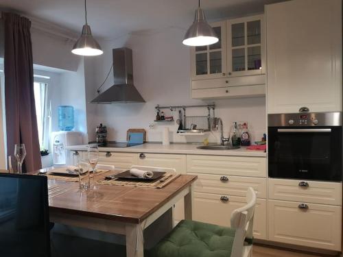 a kitchen with a table and a counter top at Lovely one bedroom condo next Mall Vitan in Bucharest