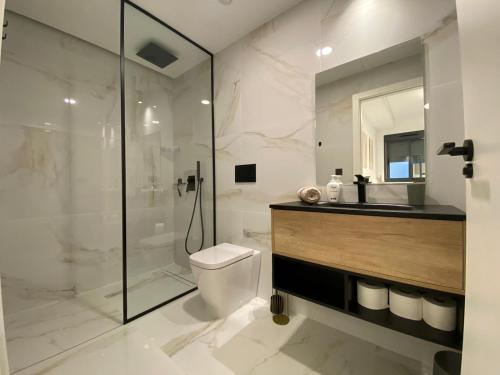a bathroom with a shower and a toilet and a sink at Paseo De La Playa in Torrevieja