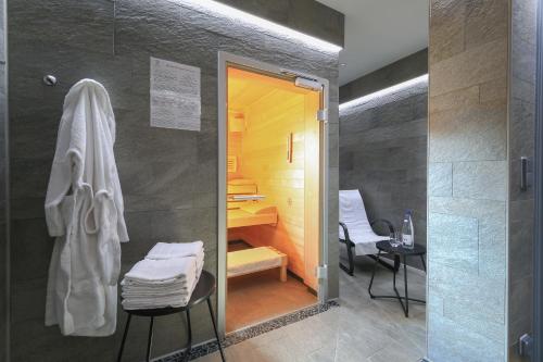 a bathroom with a shower with a sink and a desk at Hôtel Château de l'ile in Ostwald