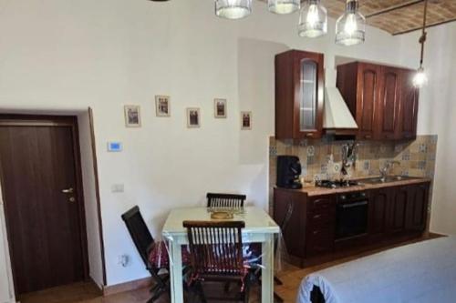 a kitchen with a table and chairs and a sink at la casa nella roccia in Scontrone