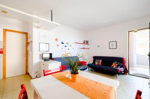 a living room with a table and a couch at Appartamento a 20mt dal mare con piscina condominiale in Marcelli