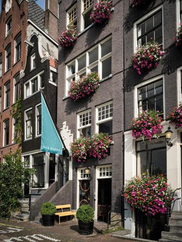 a building with flower boxes on the side of it at Max Brown Hotel Canal District, part of Sircle Collection in Amsterdam