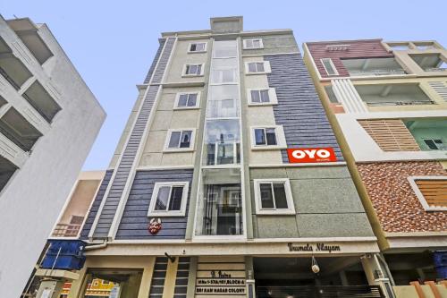a tall apartment building with a sign on it at Super Hotel O Honey Heights Near Botanical Garden in Kondapur
