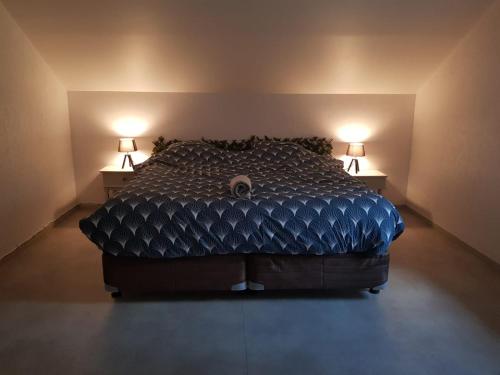 a bedroom with a bed with two lamps on both sides at Auberge De Carlucet in Carlucet