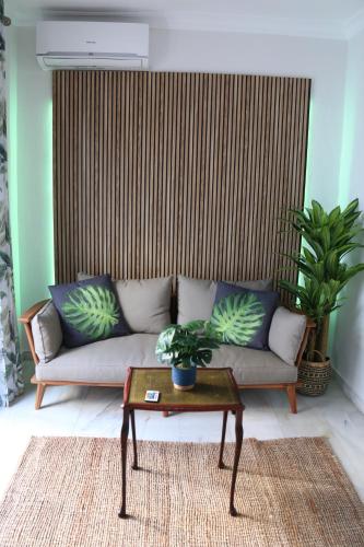 a living room with a couch and a table at Tropical Old Town Marbella in Marbella