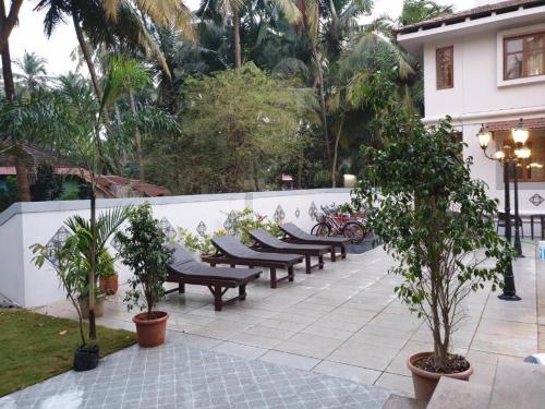 a row of benches sitting next to a fence at Coastal Suites Apart Hotel ---- 8 minutes walk to beach in Benaulim
