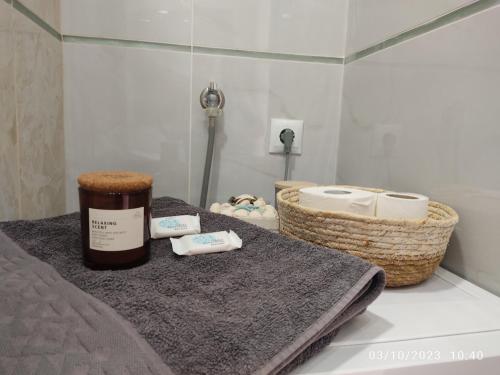 a bathroom with a bed with towels and baskets at Las Hermanas for 2 in Perea