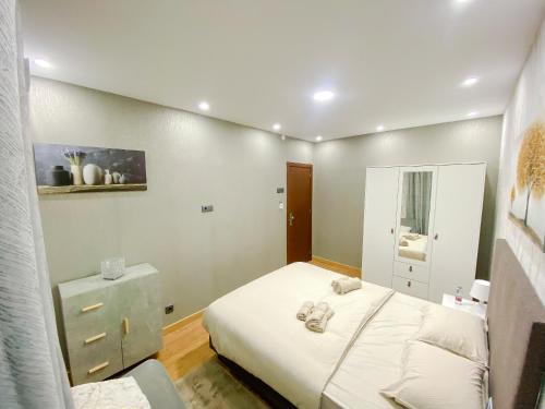 a small bedroom with a bed and a dresser at ODIVELAS METRO RESIDENCE in Odivelas