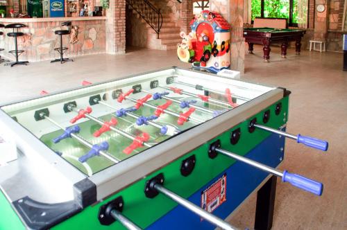 a foosball table in a living room with a table at Belkon Hotel in Belek