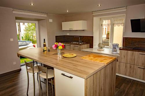 a kitchen with a large island with a counter top at Appartement de 2 chambres avec terrasse amenagee et wifi a Mittlach in Mittlach
