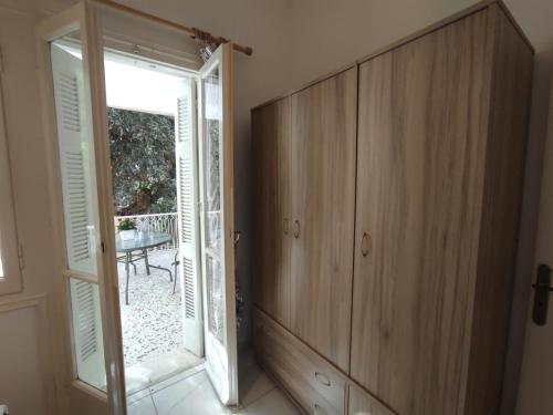 a room with a door open to a patio at Gina's cozy home in Athens