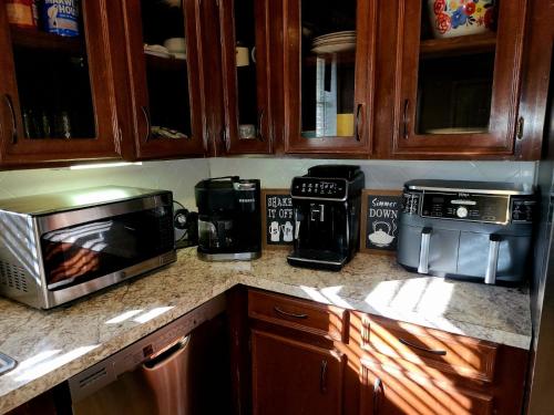 a kitchen counter with a microwave and other appliances at Cozy quiet retreat. in Beaumont