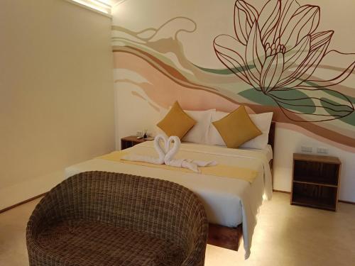 a bedroom with a bed with a flower mural on the wall at Kawai Duli Bungalows in El Nido