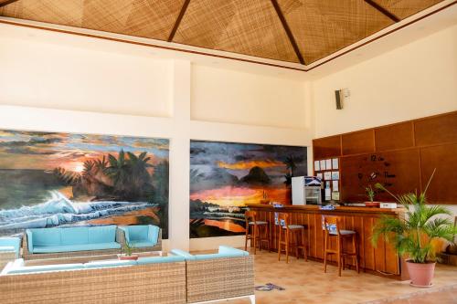 a living room with a large painting on the wall at Amphitrite Resort in Panglao