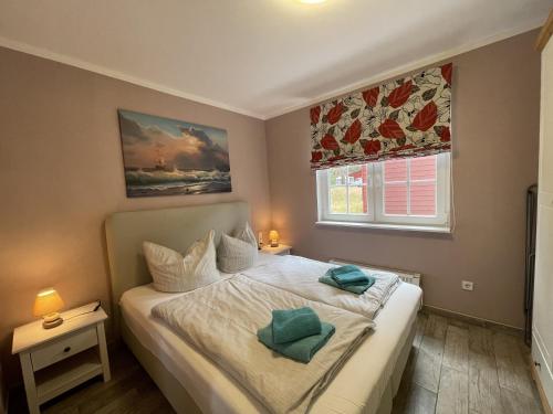een slaapkamer met een bed met 2 kussens erop bij Ferienhaus Eichelhäher in Zossen