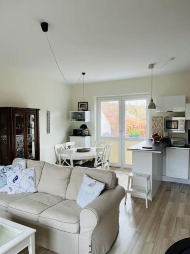 a living room with a couch and a kitchen at Mulberry House in Gdańsk